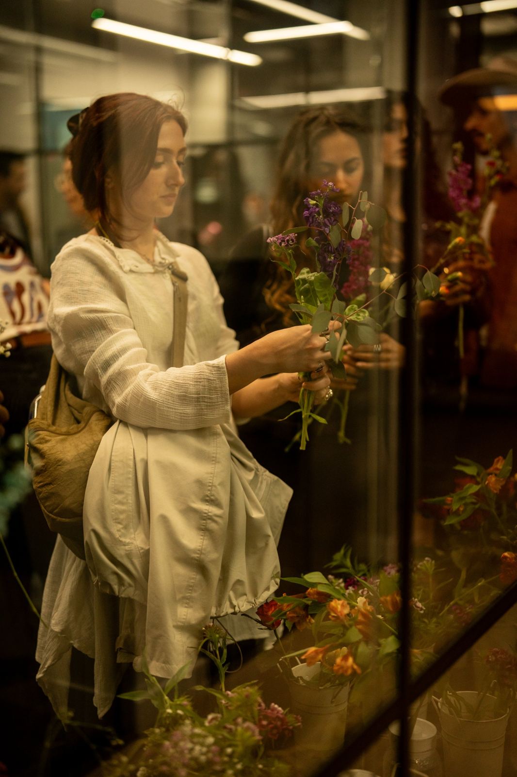 A guest holding a handful of stocks and gypsophila, choosing her next stem
